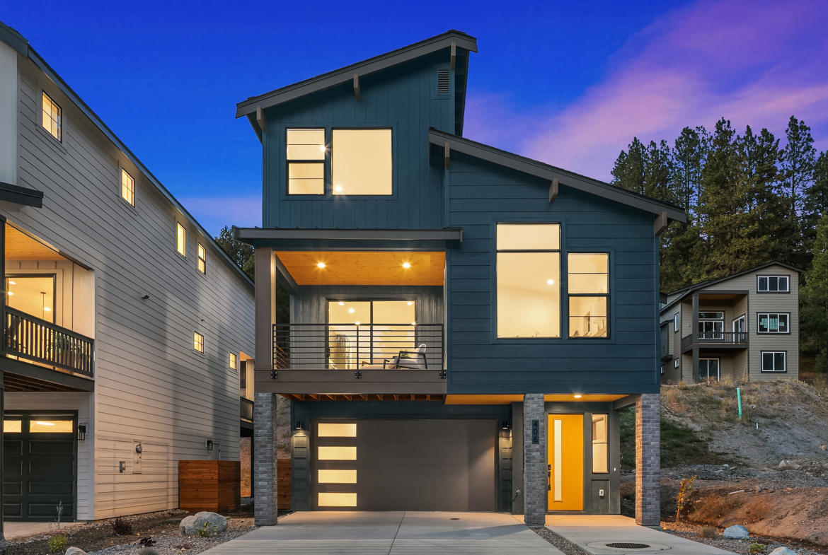 three story home in Cle Elum with blue paint taken at twighlight so the windows are illuminated