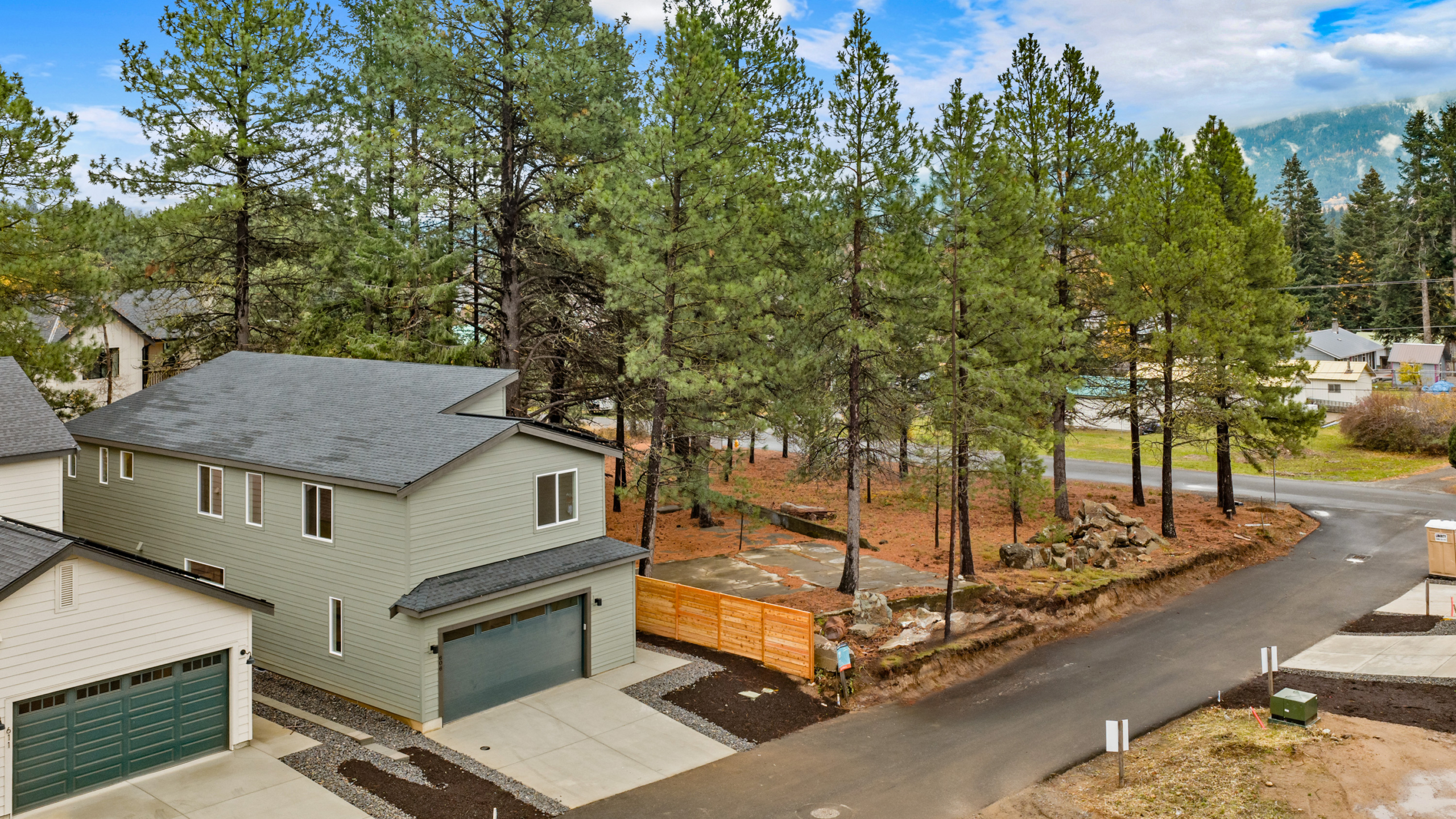 Ederra 19 exterior with ally load garage and tree lined property