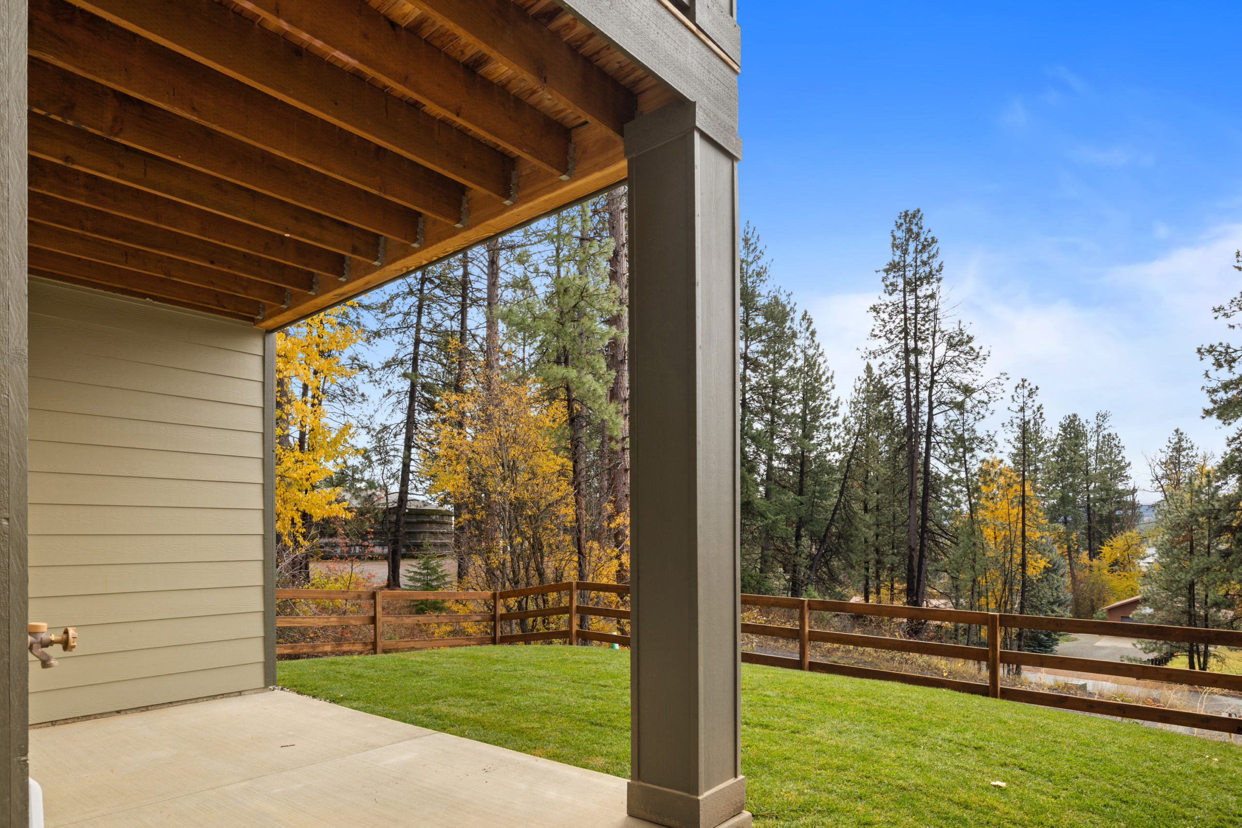 view of the backyard from Ederra lot 6 with open space in the fall