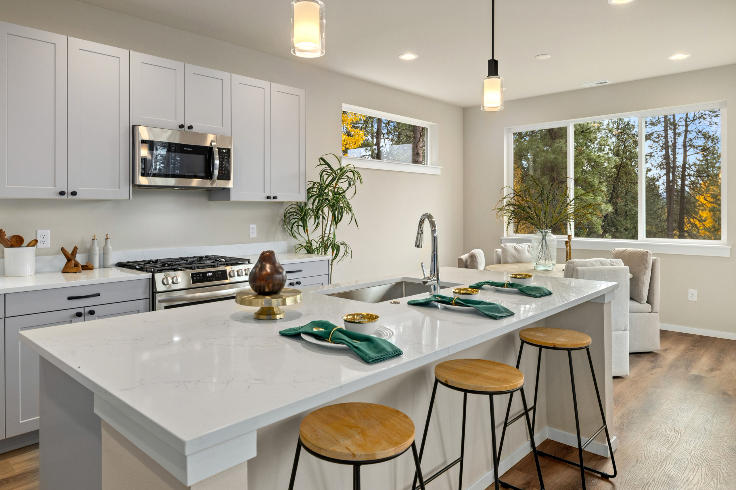 The view from the Ederra 6 kitchen with trees and light grey cabinets