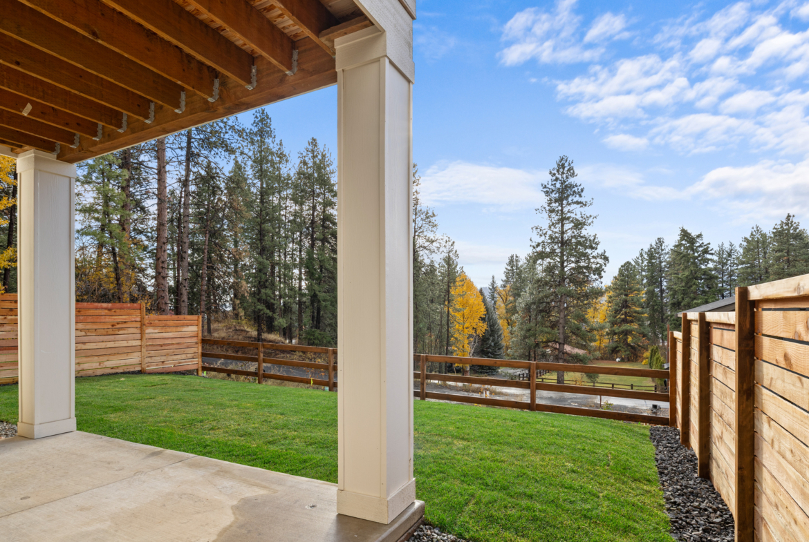 Ederra Lot 7 The Naches in Cle Elum by Trailside Homes view from the covered porch of the split rail fencing and trees