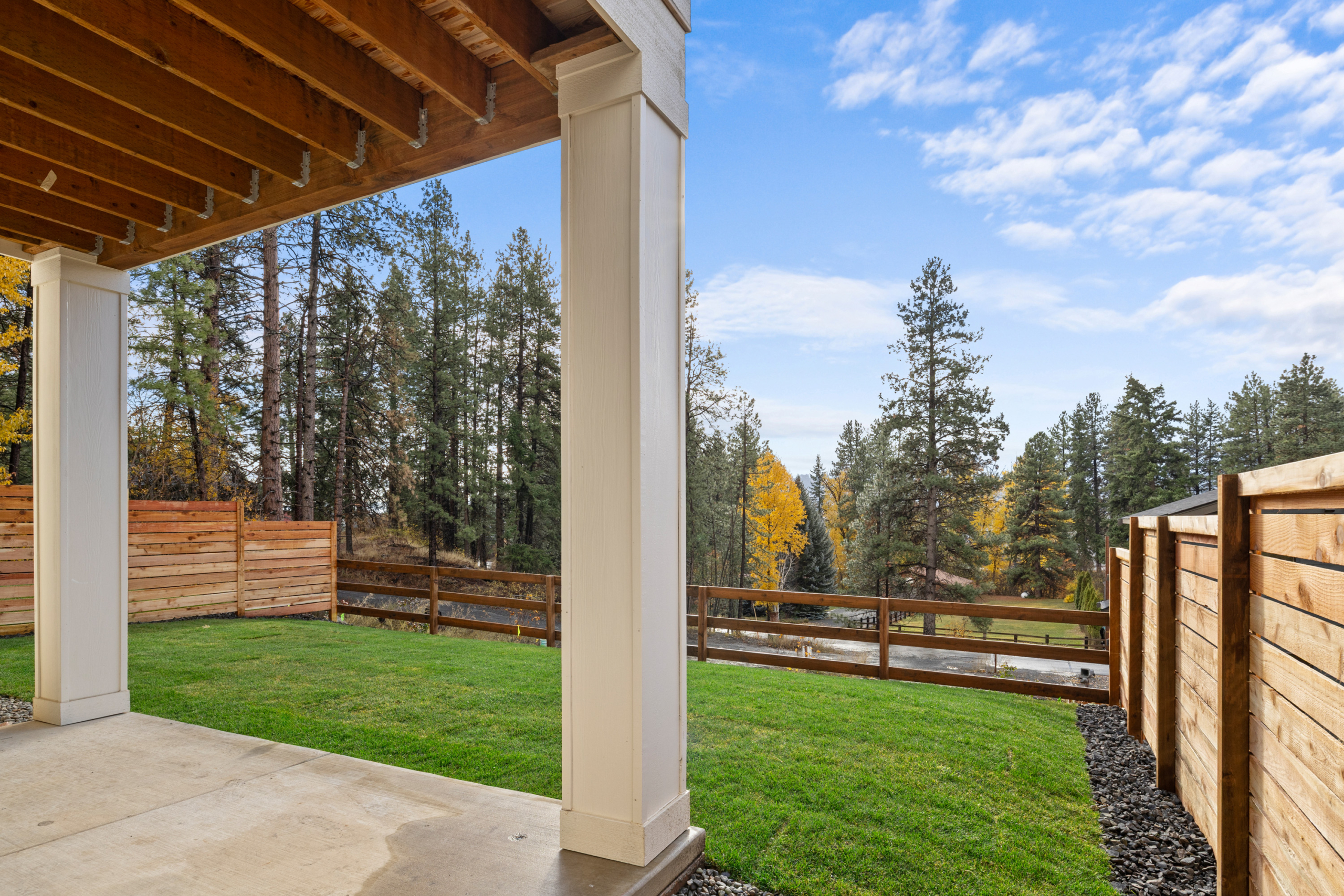 Ederra Lot 7 The Naches in Cle Elum by Trailside Homes view from the covered porch of the split rail fencing and trees