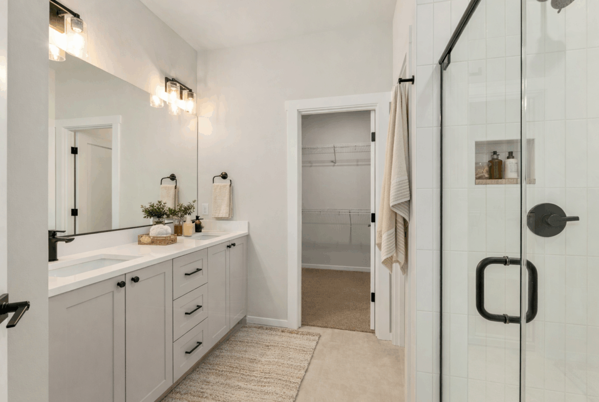 Peoh Point Ederra homesite 22 primary suite double sinks, walk in closet and shower virtually staged
