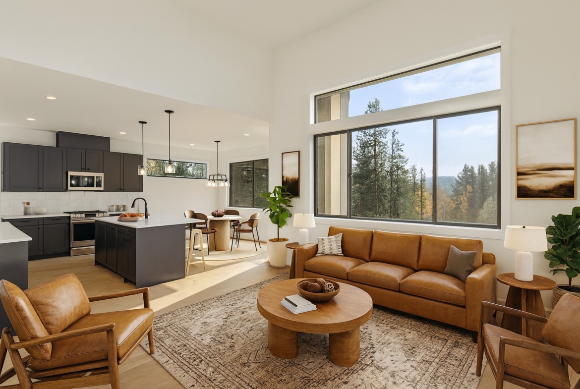 The Naches Ederra 7 Living room with leather couches and view of the kitchen and outside views of the mountains and trees