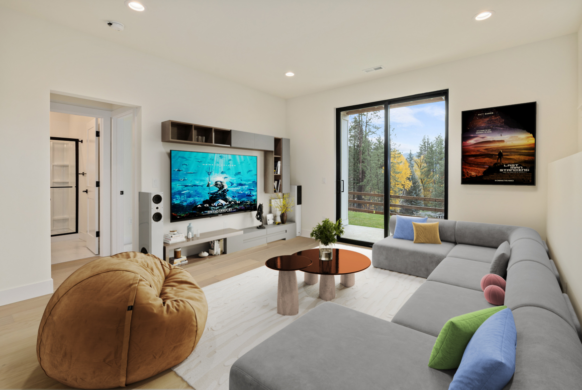 The Naches rec room decorated as a movie room with a grey couch and a leather bean bag chair