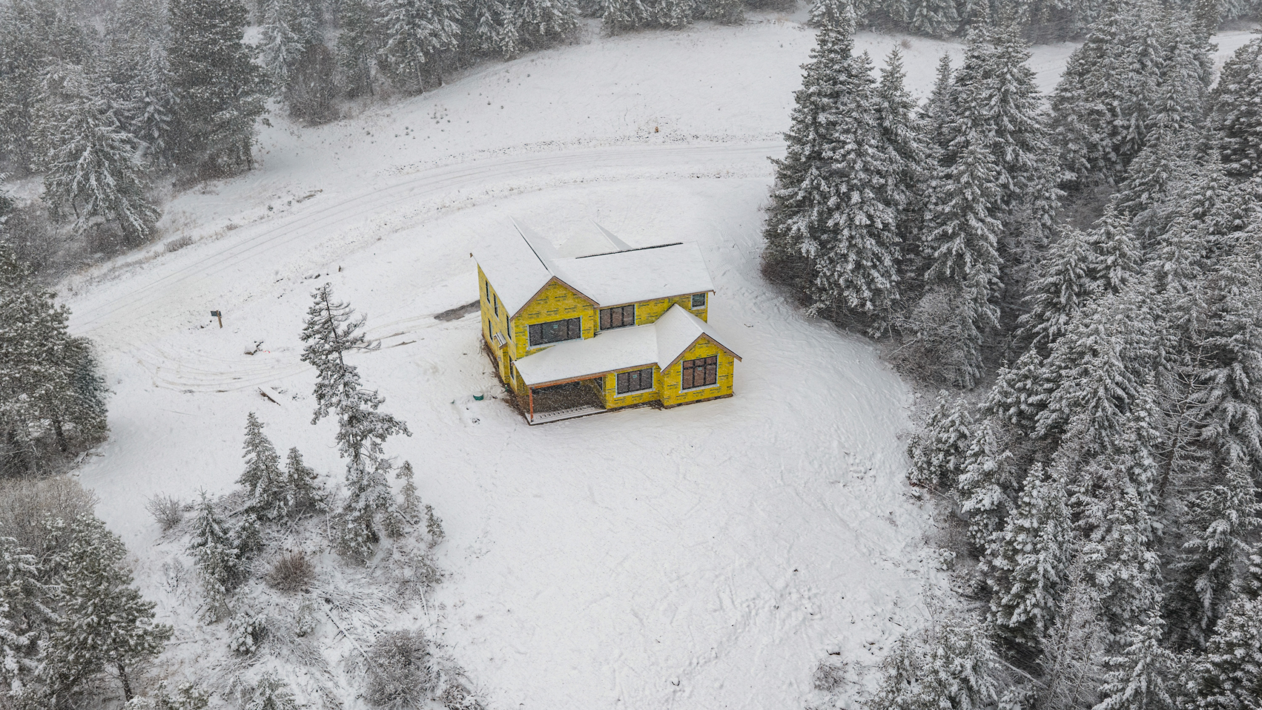 Skyline Ridge homesite 55 progress photo aerial shot covered in snow