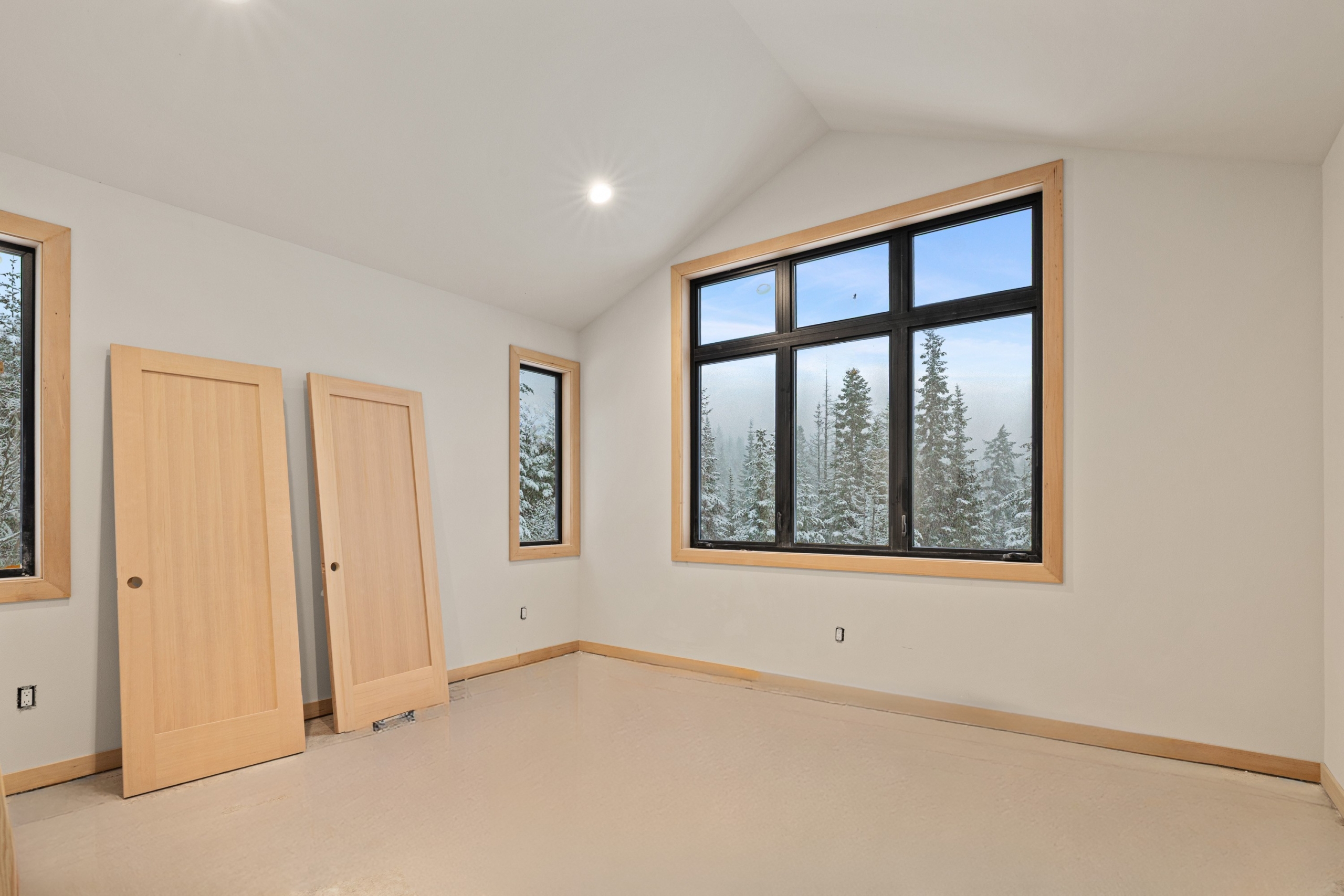 Skyline Ridge homesite 55 progress photo pf the master bedroom and snowy tree view