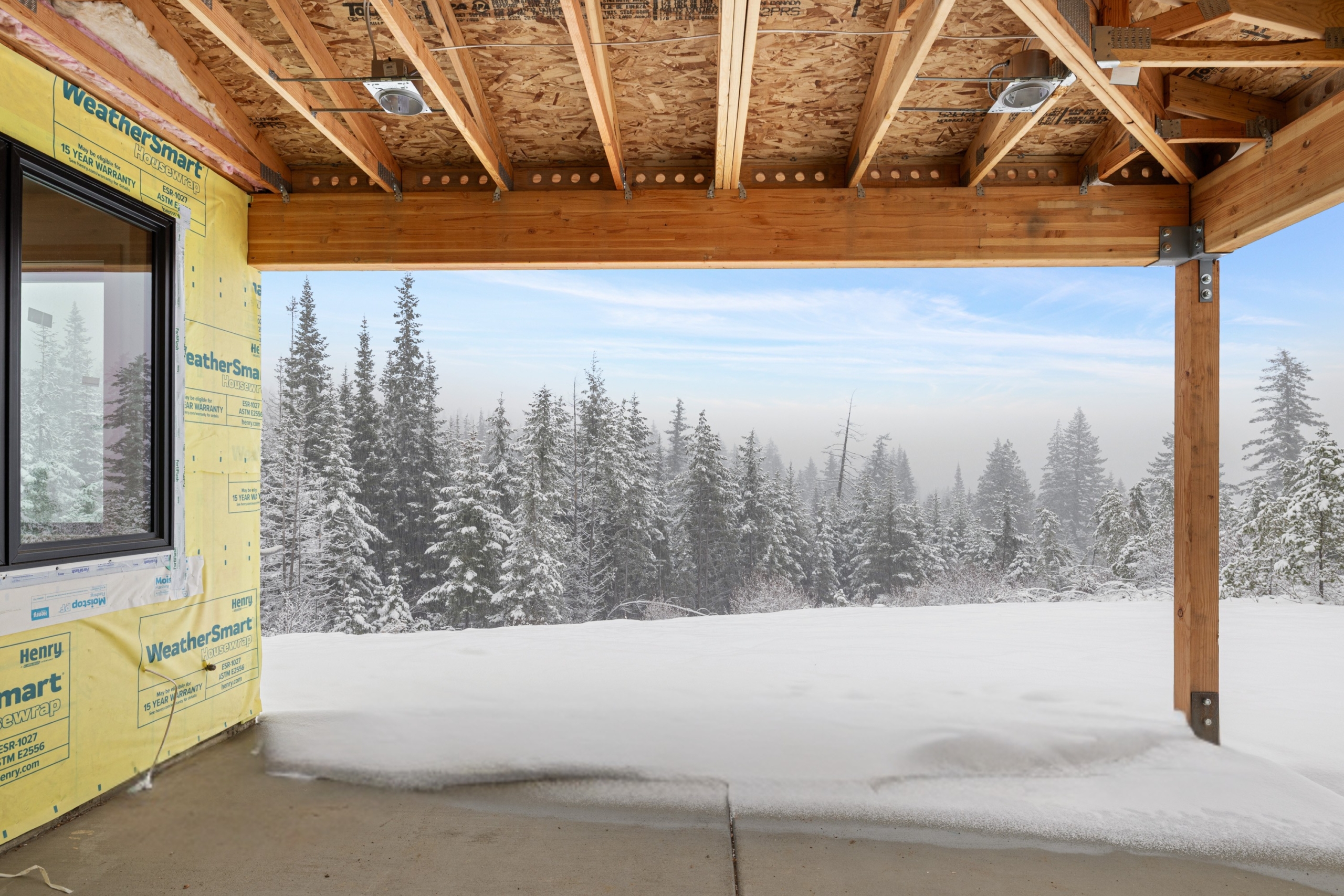 Skyline Ridge homesite 55 progress photo covered patio view covered in snow
